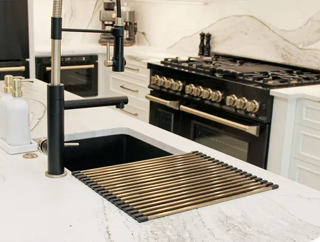 Modern sink with black and chrome details, featuring sleek fixtures and a stylish, minimalist design. Kitchen remodeling in Sarasota by Kirkplan Kitchen & Bath.
