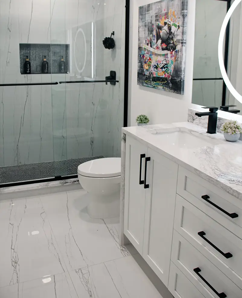 All-white walk-in shower in Jackson bath featuring sleek tilework, frameless glass enclosure, and minimalist fixtures.