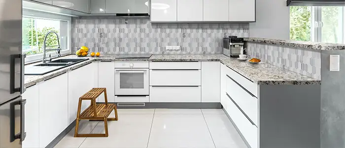 Bright modern kitchen featuring all-white cabinetry, countertops, and walls for a clean, minimalist aesthetic.