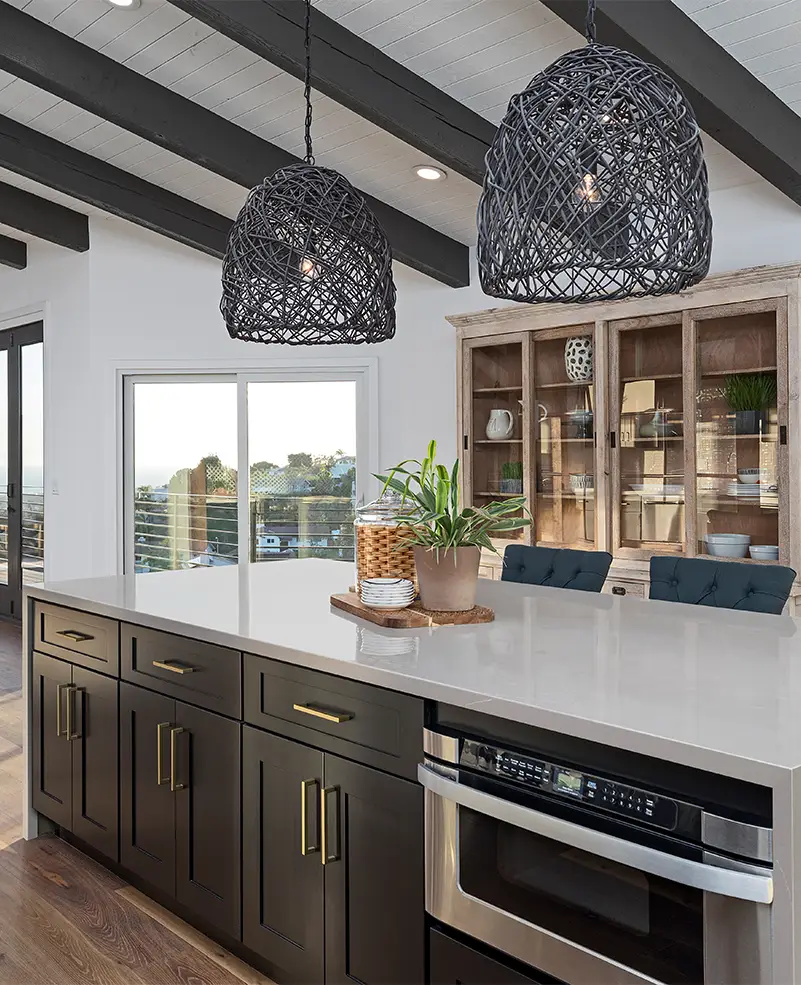 : Renovated coastal kitchen in Florida featuring soft blue cabinetry, white quartz countertops, and natural wood accents in a bright, beach-inspired layout.