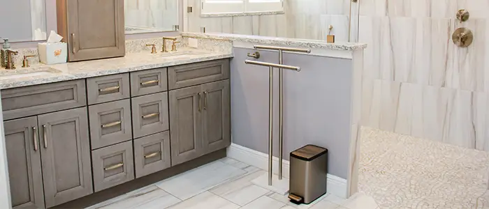 Bathroom with sleek grey cabinets and a white floor, showcasing a modern, serene design with clean lines.