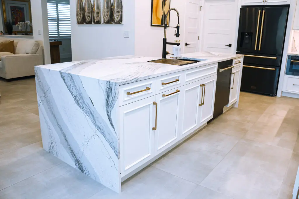 Bradenton kitchen remodel with white cabinetry and quartz countertop. Symbol on quartz vs granite countertops debate.