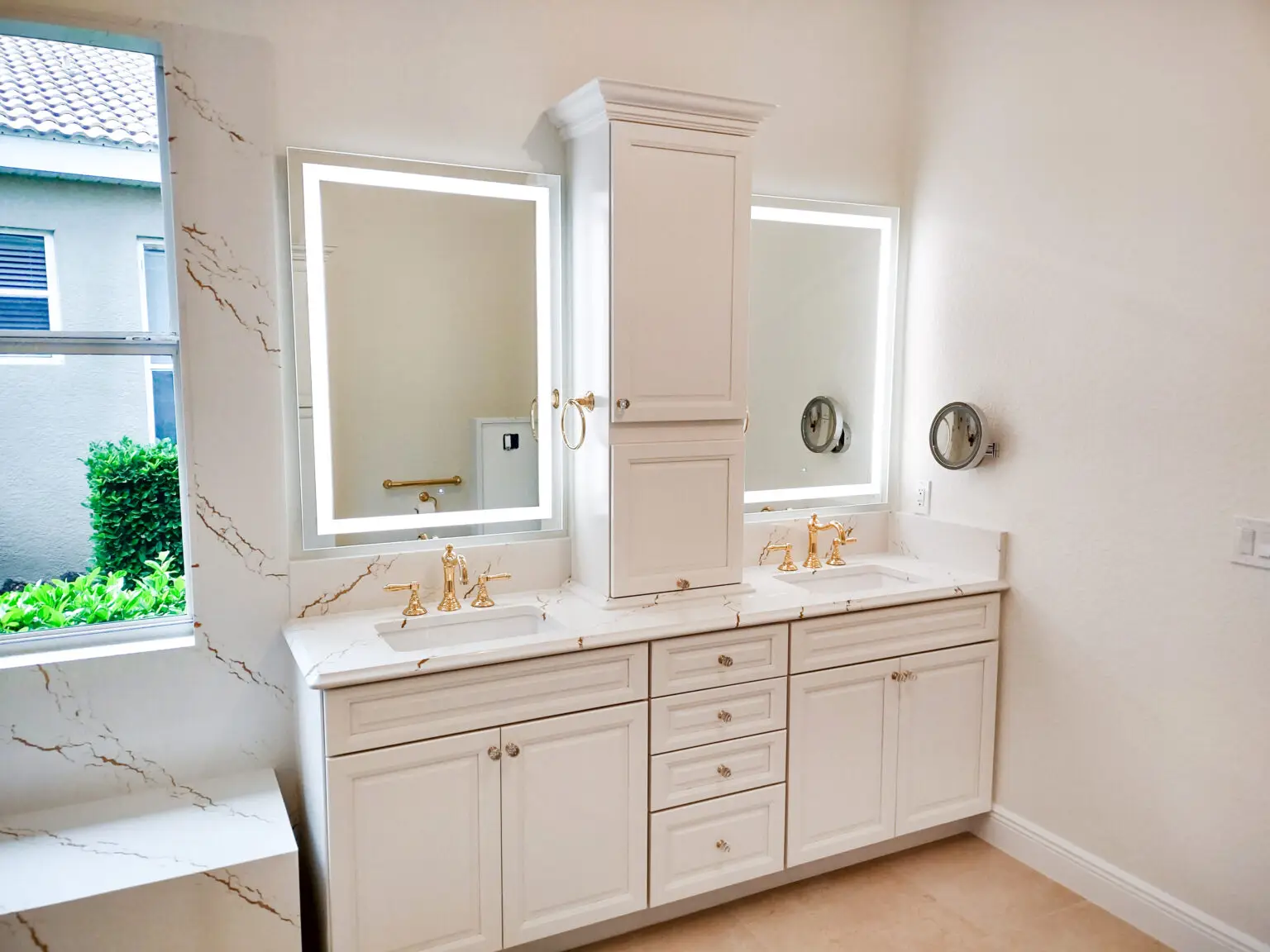 Venice, Florida master bathroom remodel by Kirkplan Kitchen & Bath, featuring LED-lit mirrors and sleek Cambria Inverness Gold quartz countertops with modern hexagonal tile flooring. Bathroom remodeling in Venice, Sarasota.