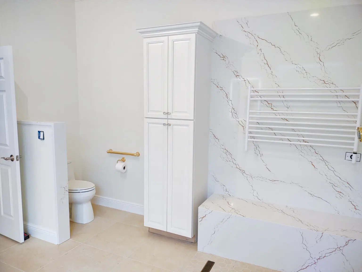 View of sleek cabinets in a Venice, Florida master bathroom remodel, showcasing modern design paired with Cambria Inverness Gold quartz countertops for a cohesive and stylish look.