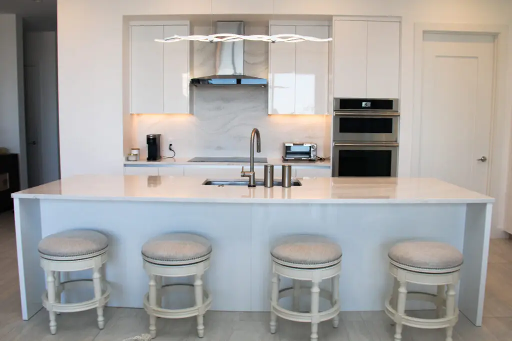 Light-colored modern kitchen in Sarasota, FL with warm tones, soft lighting, and minimalist design—creating a cozy and inviting space aligned with 2025 kitchen trends.