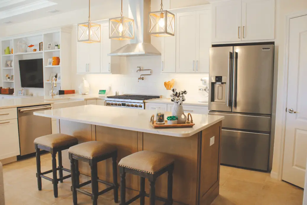 Contemporary kitchen remodel in Sarasota, FL, featuring white cabinets, quartz countertops, and open shelving—highlighting popular 2025 kitchen design trends.